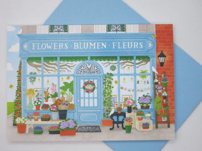 Physisches Kartenfoto des Blumenladen-Motivs mit blauem Umschlag – Der zauberhafte Blumenladen PKGR37