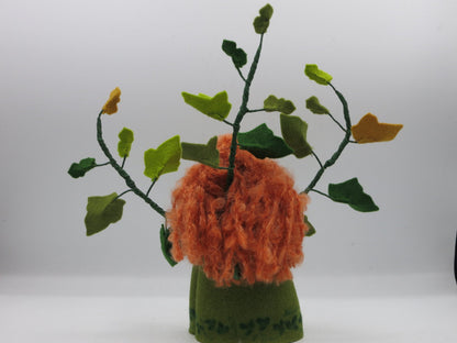 Rückansicht des handgefertigten Efeu-Blumenkindes mit rotem Lockenhaar und grünen Filzranken für die Herbstdekoration
