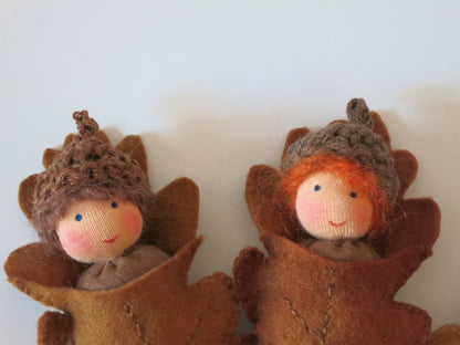 Zwei handgefertigte Eichelbabys als Blätterkinder aus Filz für die herbstliche Waldorf-Dekoration.