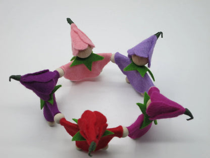 Draufsicht auf den geschlossenen Kreis aus fünf handgefertigten Krokus-Blumenkindern mit spitzen Filzblütenhüten.