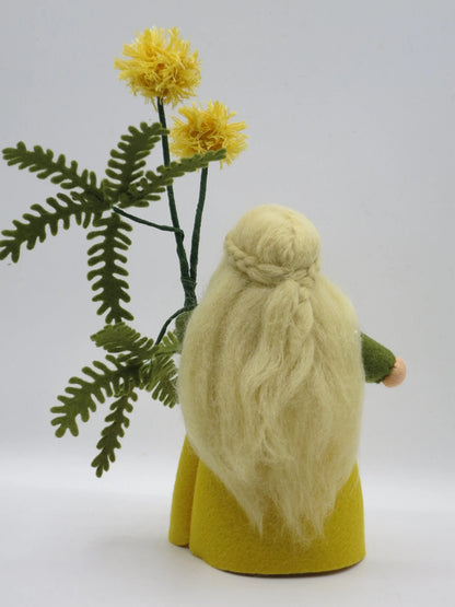 Detailansicht der gelben Mimosen-Pomponblüten aus Wollgarn mit grünem Farnblatt