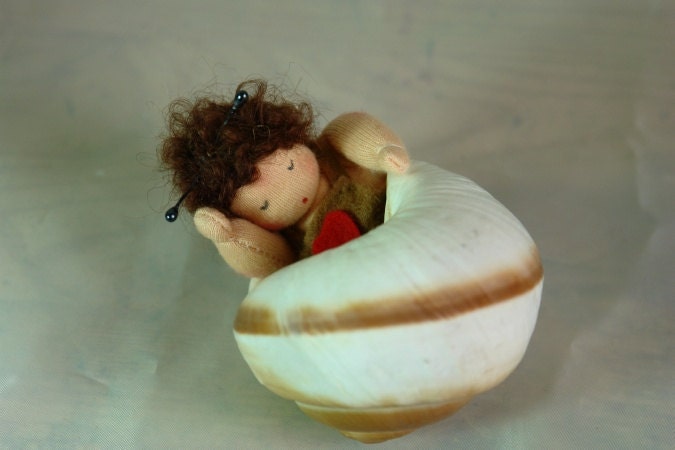 Müdes Schneckchen aus Wollfilz schläft in einem echten Schneckenhaus, Waldorf Jahreszeitentisch.