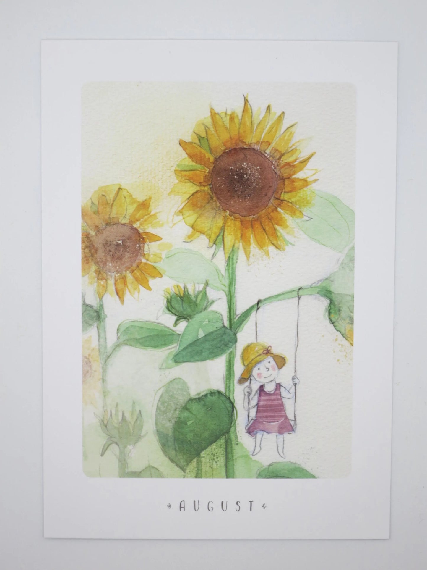 Waldorf Postkarte August: Maedchen auf Miniatur-Schaukel an riesigem Sonnenblumenstiel, Aquarell von Stefanie Messing