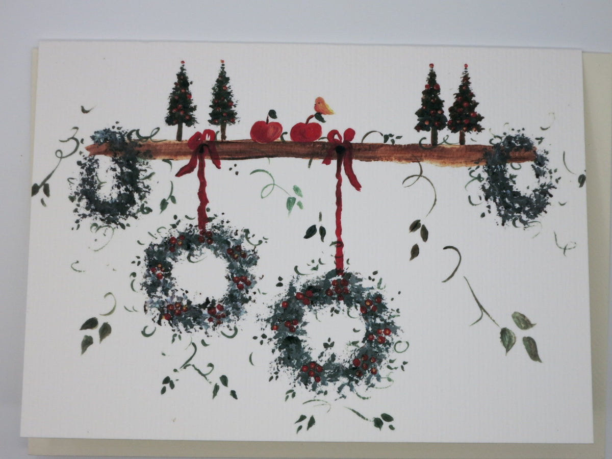 Weihnachtskarte fünf Kränze an einem Ast mit Vogel und Äpfeln