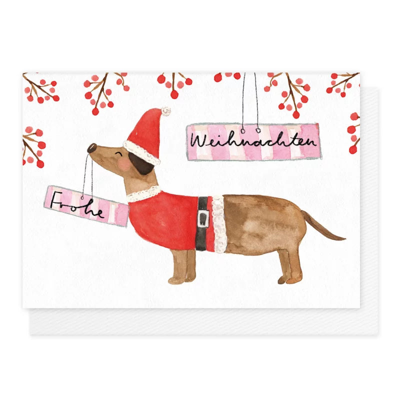 Weihnachtskarte Dackel im Weihnachtsmann-Kostüm mit Frohe-Weihnachten-Schildern im Maul