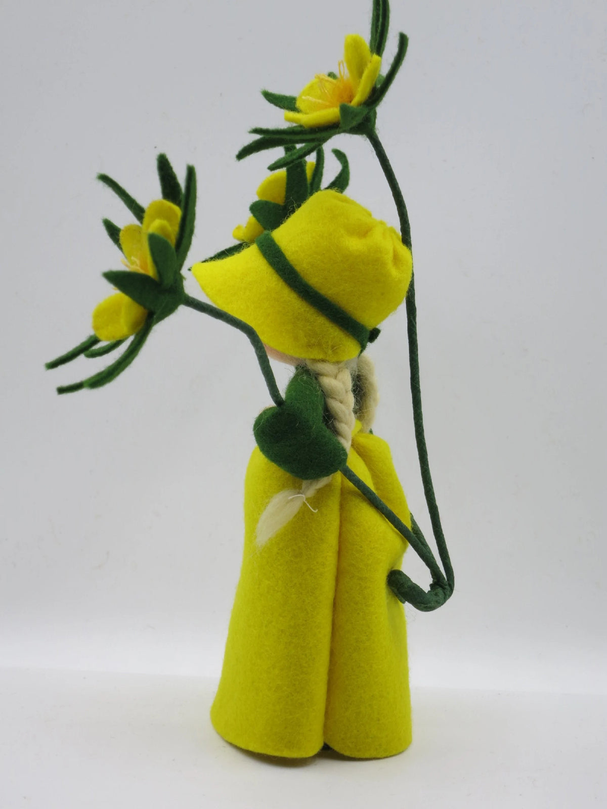 Winterling-Blumenkind seitlich mit grünem Kragen und gelben Filzblüten